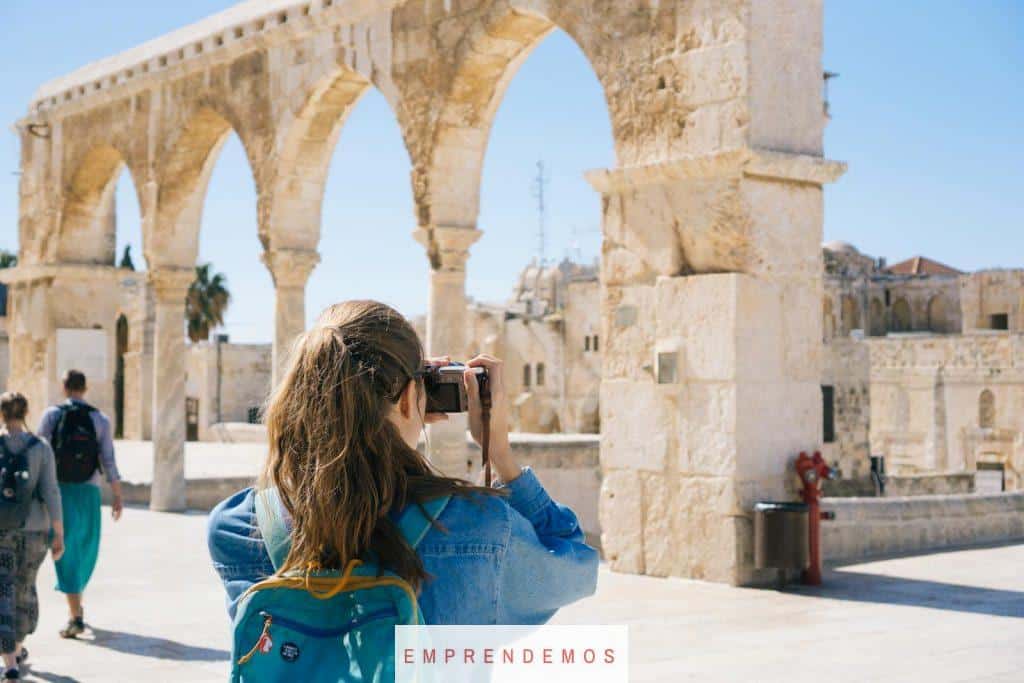 Woman Taking Pictures of Ruins