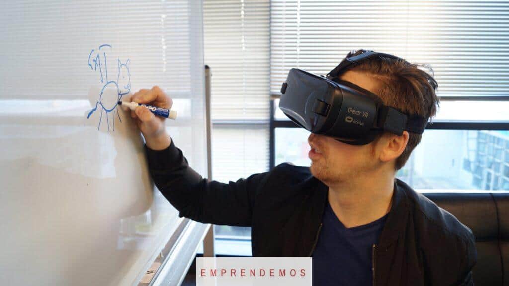 Person Wearing Black Vr Box Writing On White Board