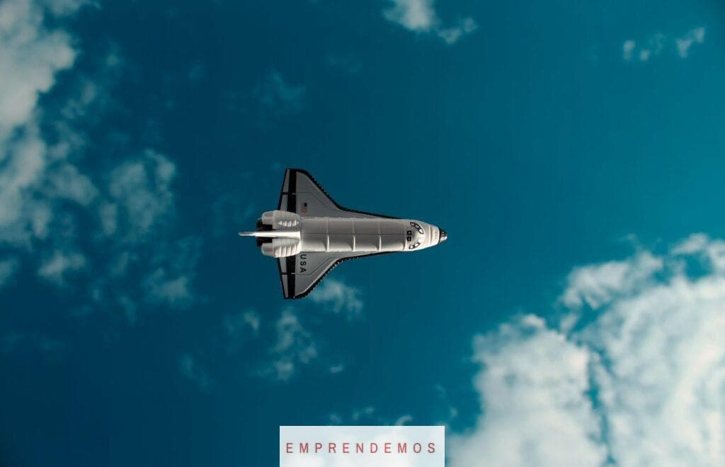 white and black jet plane in mid air under blue sky during daytime