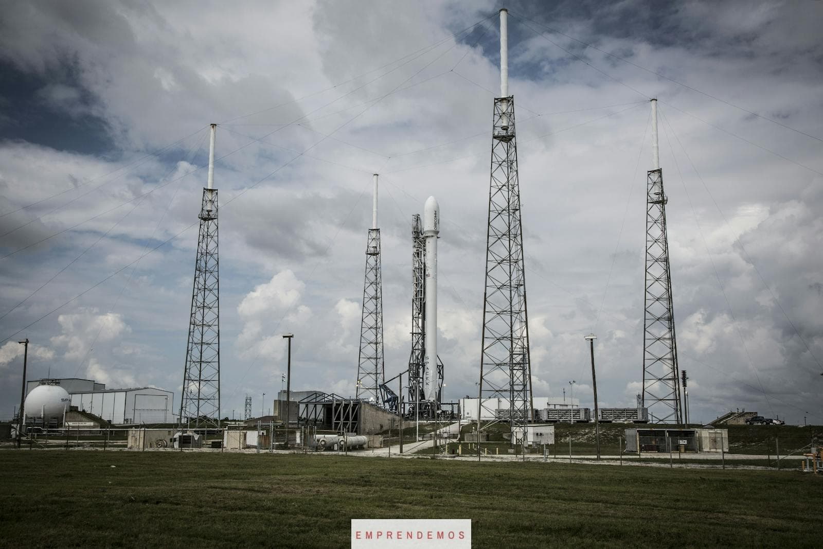Industrial rocket launch pad with tall towers under a cloudy sky, perfect for technology and energy themes.