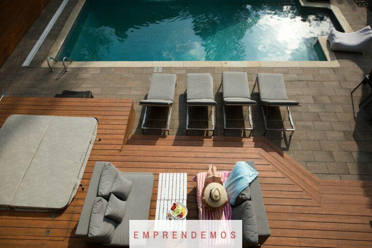 four gray loungers near pool