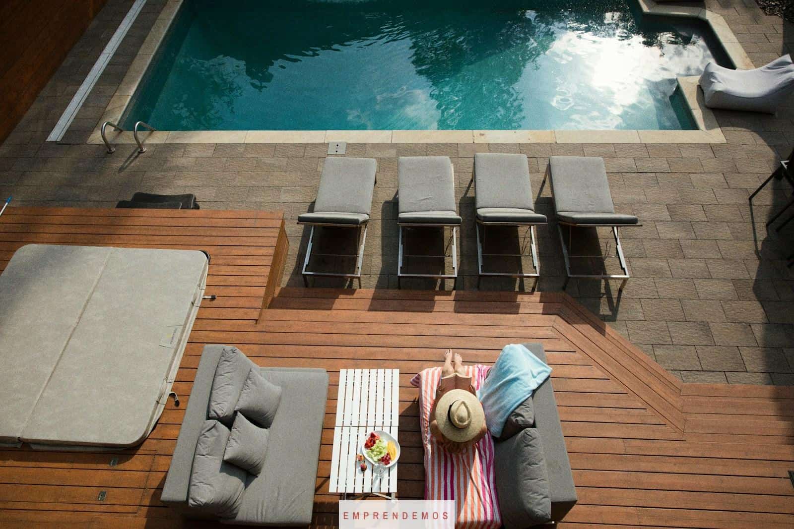 four gray loungers near pool